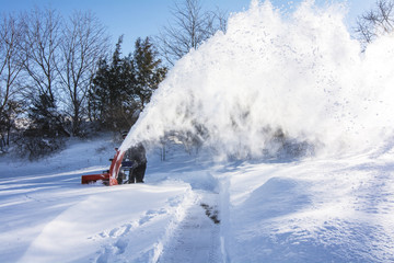 Man plowing the snow in the morning
