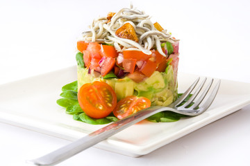 Vegetables and baby eel or elvers tartar  on white background
