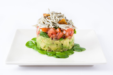 Vegetables and baby eel or elvers tartar on white background
