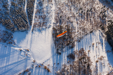 aerial view of  paramotor over the forest in winter