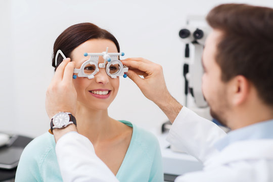 Optician With Trial Frame And Patient At Clinic