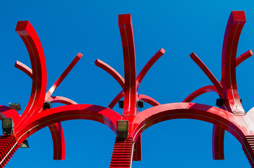 Brightly  Red Street light on blue sky viewed from below