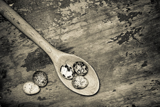 Composition with quail eggs. Wooden texture for background. Tone