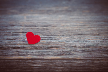 Red heart on old wooden background