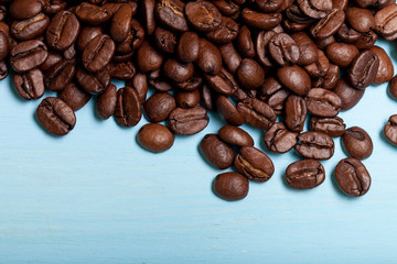 Coffee beans on blue wooden table