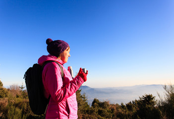 young woman travel in winter mountains