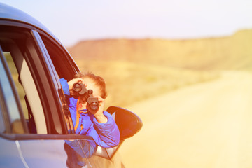 happy little boy travel by car in mountains