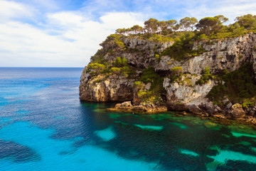 Fototapeta na wymiar Cala Macarelleta coast, Paradisiac place at Menorca with transparent and turquoise water.