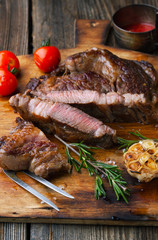 Grilled ribeye steak marbled meat with salt, rosemary and garlic