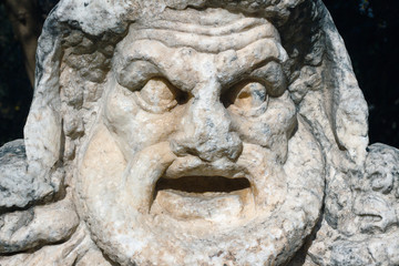 Obraz premium Ancient mask./ Antique sculpture in the castle of St. Peter in Turkey.