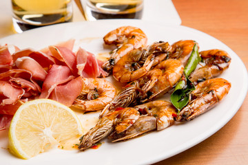 Beer snack of cold meats and fresh boiled shrimp with spices and lemon