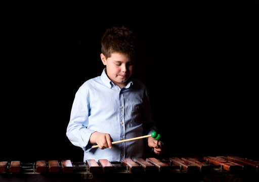 Boy playing on xylophone