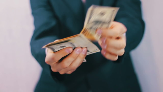 Businessman Counts Money in Hands.