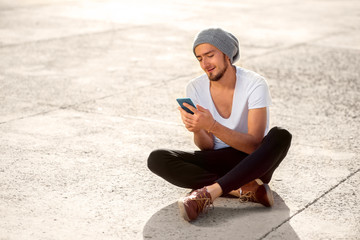 Man with smart phone on the ground