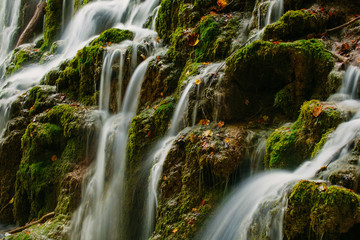 Detailed view of a beautiful crystal watered waterfall in the forest