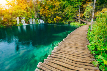 Majestic view on turquoise water and sunny beams in the Plitvice Lakes National Park. Croatia....