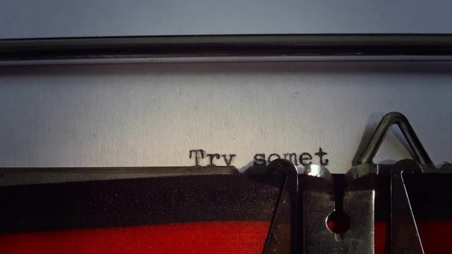 Message is "Try something new". Old typewriter types message. Close up on words.