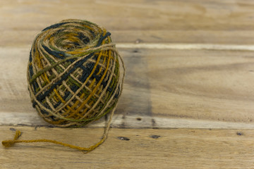 roll of colorful jute, string, hemp rope on wooden backgroun