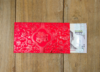 Fototapeta na wymiar Thai money in red envelope for chinese new yea