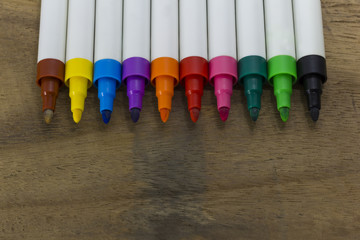 colorful marker pen on wooden background