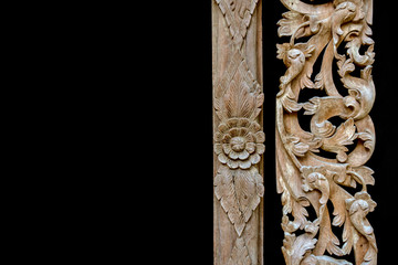 Thai wood carving of flowers on a black background