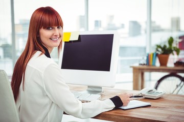 Hipster businesswoman using her computer