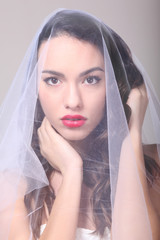 Fototapeta premium Beautiful girl with a white tulle