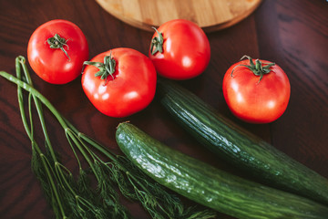 vegetables for salad, greens on the table in the kitchen