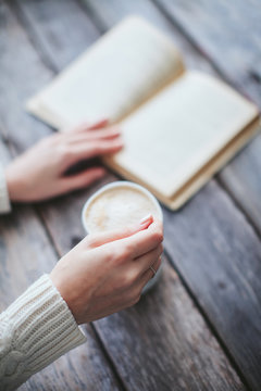 Female Hand Stir Coffee On Wooden Table