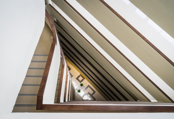 Abstract interior fragment, triangle shaped flight of stairs, looking down