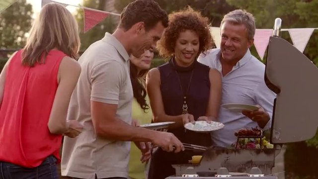 Mature Friends Enjoying Outdoor Barbeque Shot On R3D