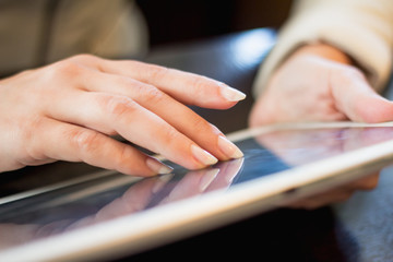 woman holds a smartphone telephone, works on the digital tablet, soft focus, close up