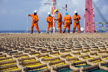 Offshore Workers Working On The Helideck of A Construction Barge Stock 