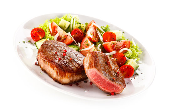 Grilled steaks and vegetable salad 