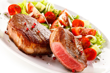 Grilled steaks and vegetable salad 