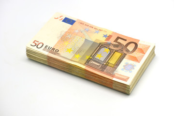 Obraz na płótnie Canvas Money pile of 50 Euro banknotes isolated in white