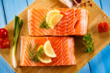 Fresh raw salmon fillets on cutting board 