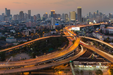 Fototapeta na wymiar Aerial view city downtown background with highway intersection during twilight