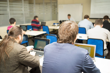 Fototapeta premium behind people study or lecture or meeting or do workshop in classroom with notebooks in a classroom