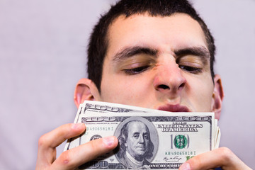 Man sniffing dollars