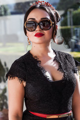 Pretty woman portrait wearing sunglasses and red lipstick