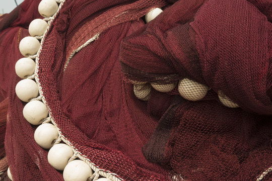 Close-up Of White Fishing Floats On Red Drift Net    