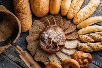 Different bread and bread slices, pastries combination, rye bread with grains, food background © martingaal