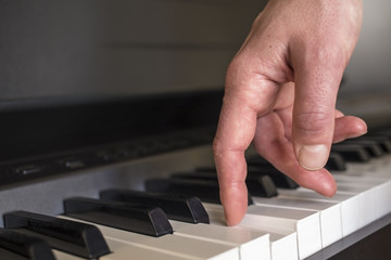 Fototapeta na wymiar fingers click on the piano keys as if the legs 