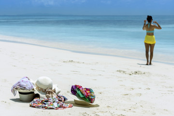 Summer hat and colourful scraf on the beach