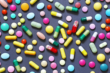 Colorful pills on grey background