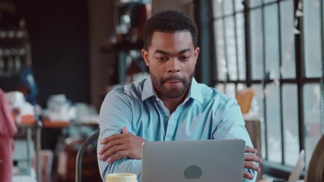 Businessman Using Laptop At Desk In Busy Office Shot On R3D