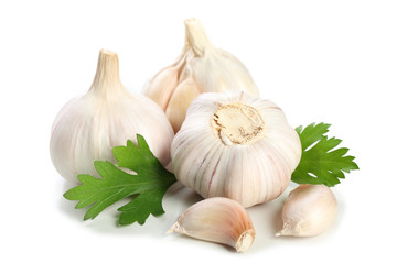 Garlic with leaves of parsley isolated on white