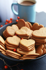 Fototapeta na wymiar Heart shaped biscuits and a mug of cocoa on a table