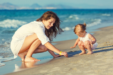 Mother and daughter playing on the beach